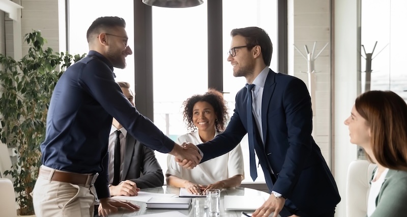 Happy International Businessmen Handshake At Office Business Meeting